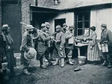 French soldiers returning from the trenches make a halt for refreshment, c1914