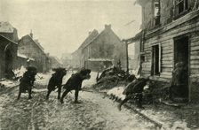 French troops crossing a village street under German fire, First World War, 1914-1915, (c1920). Creator: Unknown