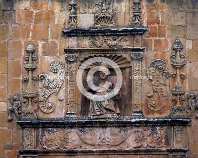 Front door of St. Peter's Cathedral, crowned by the seated image of Saint Peter Pope, embedded in…