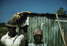 FSA - Tenant Purchase borrower? in front of their house, Puerto Rico, 1941 or 1942. Creator: Jack Delano