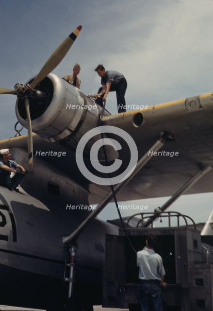 Fueling a plane at the Naval Air Base, Corpus Christi, Texas, 1942. Creator: Howard Hollem.