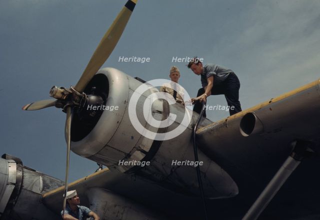 Fueling a plane at the Naval Air Base, Corpus Christi, Texas, 1942. Creator: Howard Hollem.
