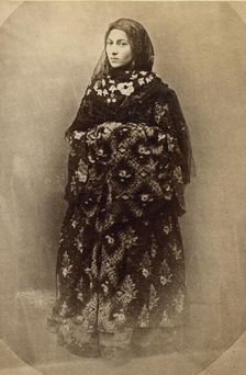 Full-length portrait of a woman in traditional dress, facing slightly left, between 1870 and 1886. Creator: Unknown