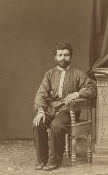 Full-length portrait of Armenian man, seated, facing front, between 1870 and 1886. Creator: Unknown