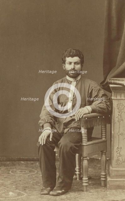 Full-length portrait of Armenian man, seated, facing front, between 1870 and 1886. Creator: Unknown.