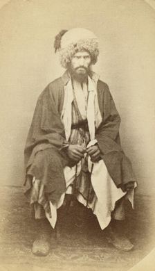 Full-length portrait of man, seated, facing front, between 1870 and 1886. Creator: Unknown