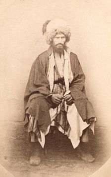 Full-length portrait of man, seated, facing front, between 1870 and 1886. Creator: Unknown