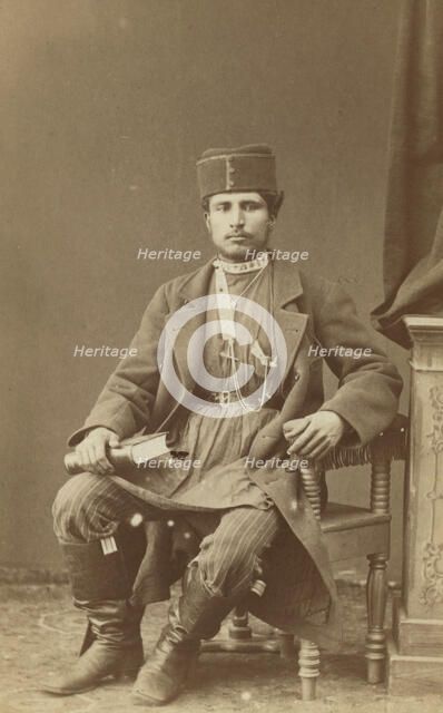 Full-length portrait of Persian man, seated, facing front, between 1870 and 1886. Creator: Unknown.