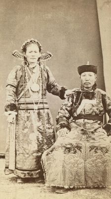 Full-length portrait of wealthy Buriat man and his wife, facing front, between 1870 and 1886. Creator: Unknown