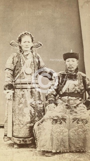 Full-length portrait of wealthy Buriat man and his wife, facing front, between 1870 and 1886. Creator: Unknown.