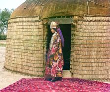 Full-length profile portrait of a woman, possibly Turkman or Kirgiz, standing..., between 1905-1915. Creator: Sergey Mikhaylovich Prokudin-Gorsky