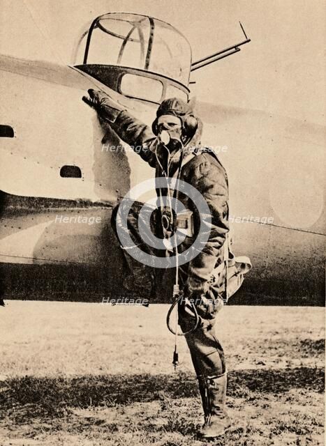 Fully Equipped for air fighting; oxygen, radio, electrically heated clothing and parachute, 1940. Artist: Unknown