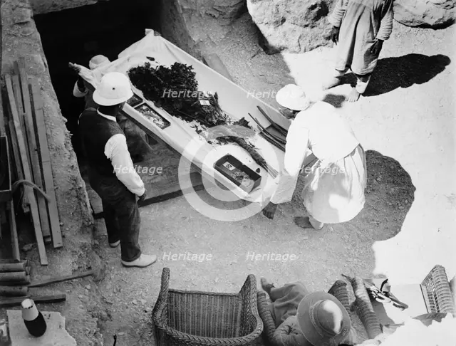 Funeral bouquet being removed from the tomb of Tutankhamun, Valley of the Kings, Egyp, 1922. Creator: Harry Burton.