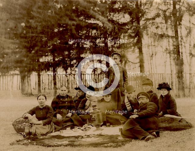 G.V. Iudina's Family with Their Guests in the Garden at the Dacha in Tarakanovo, 1907. Creator: Unknown.