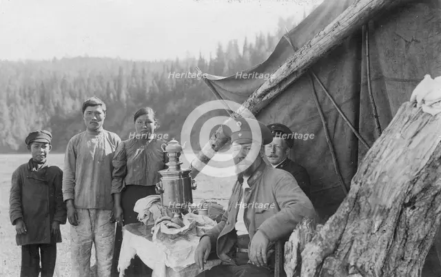 G.I. Ivanov and a Shoria Family at the Table with Samovar Near the Tent, 1913. Creator: GI Ivanov.
