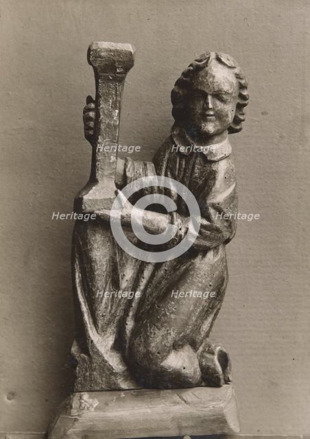 Kneeling figure with a candlestick, (1925-1930).  Creator: Unknown.