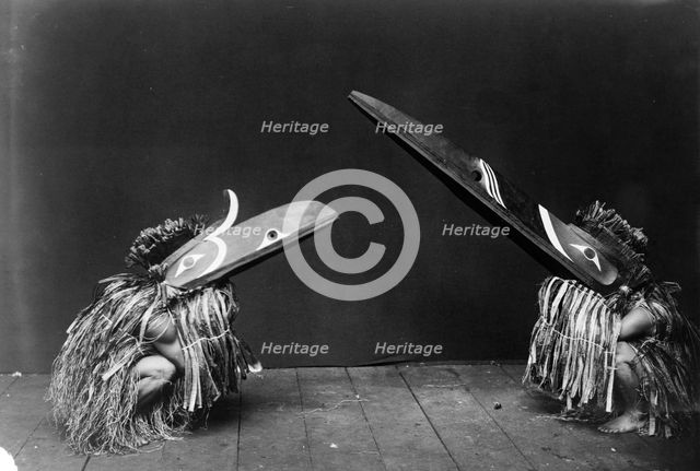 Kotsuis and Hohhug-Nakoaktok, wearing ceremonial dress, with long beaks, on their haunches..., c1914 Creator: Edward Sheriff Curtis.