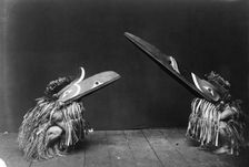 Kotsuis and Hohhug-Nakoaktok, wearing ceremonial dress, with long beaks, on their haunches..., c1914 Creator: Edward Sheriff Curtis