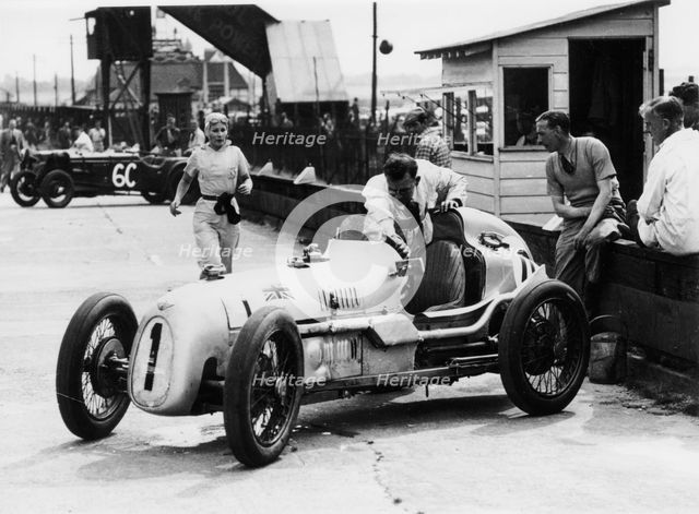 Kay Petre and Austin Seven, Brooklands, 1936. Artist: Unknown