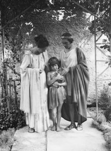 Kanellos, Vanellos and Tanagra, and child holding a cat, in dance costumes, 1929 Creator: Arnold Genthe