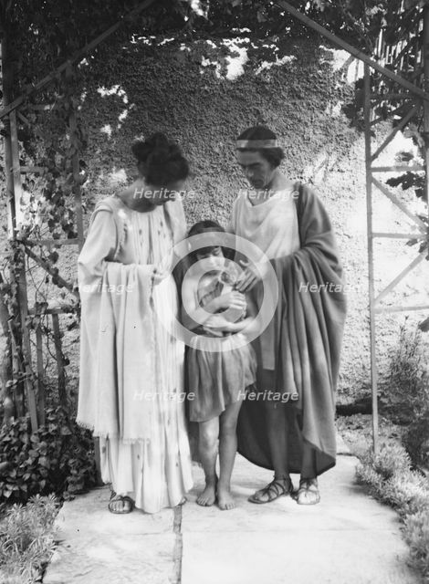 Kanellos, Vanellos and Tanagra, and child holding a cat, in dance costumes, 1929 Creator: Arnold Genthe.