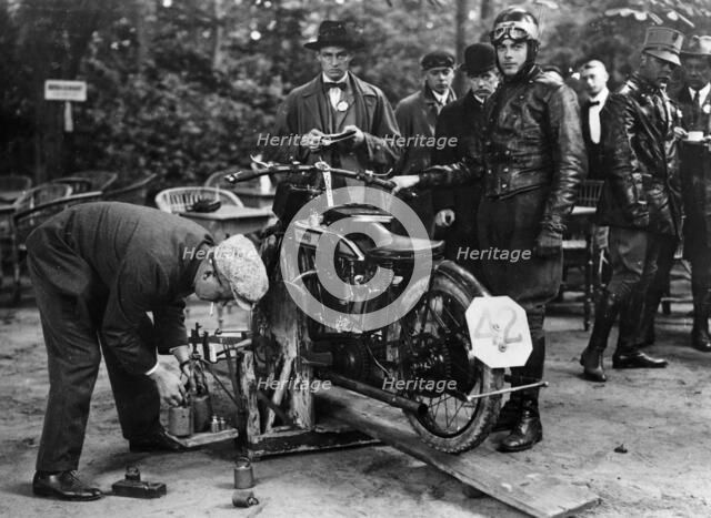Karl Burlage having his Norton bike weighed for a TT competition. Artist: Unknown