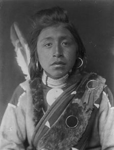 Kashhila-Wishham. Male Chinookan Indian, head-and-shoulders portrait, facing front..., c1910. Creator: Edward Sheriff Curtis
