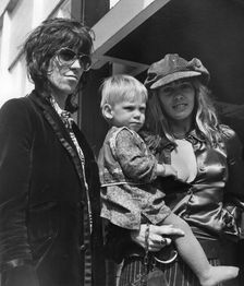 Keith Richards and Anita Pallenberg with baby Marlon, Heathrow, London, 1970. Creator: Unknown