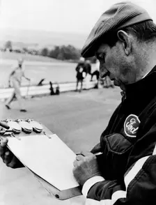 Ken Tyrrell noting down times, (c1970s?)