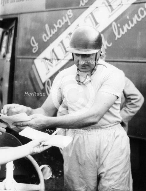 Ken Wharton signing autographs. Artist: Unknown