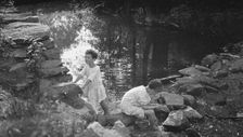 Kennerley, Richard and Morley, playing by a pond, 1912 or 1913. Creator: Arnold Genthe