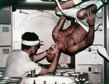 Kerwin examining Conrad on Skylab 2, 1973. Creator: NASA