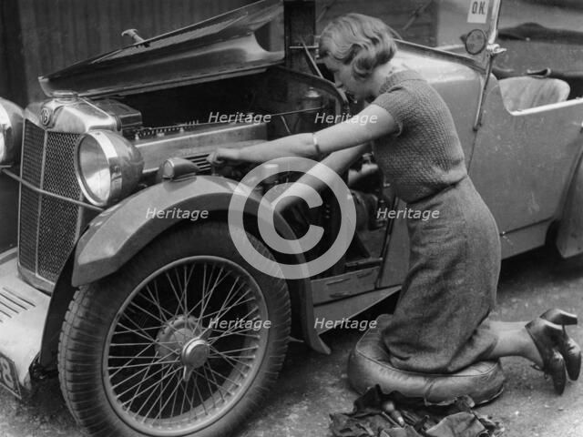 Kitty Brunell working on her MG F Magna. Artist: Unknown