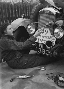 Kitty Brunell working on her Singer Junior, Monte Carlo Rally, 1928. Artist: Bill Brunell
