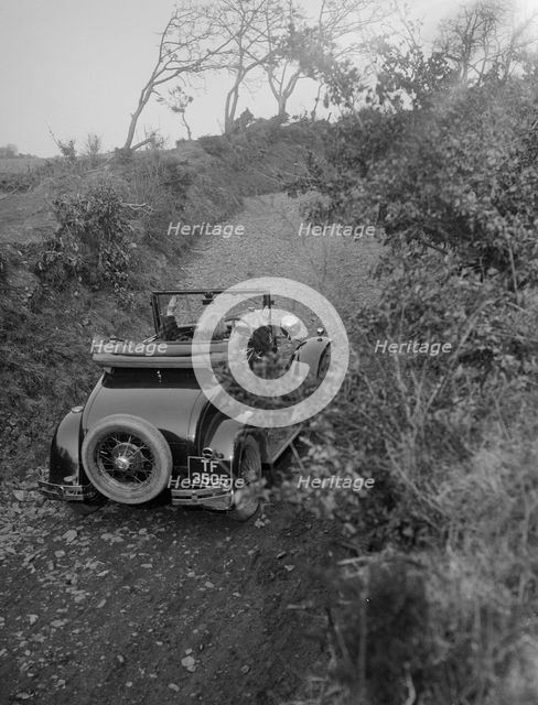 Kitty Brunell driving a 1930 2-seater Ford Model A, 1931.   Artist: Bill Brunell.