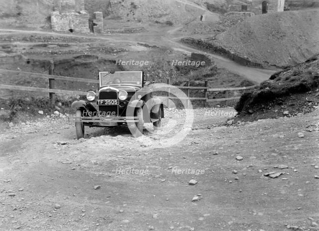 Kitty Brunell driving a 1930 Ford Model A 2-seater, 1931. Artist: Bill Brunell.
