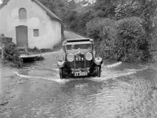 Kitty Brunell fording the River Exe in a Talbot 14/45 sportsman's coupe, Winsfors, Somerset, c1930s. Artist: Bill Brunell