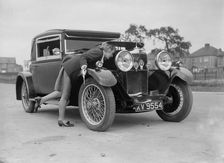 Kitty Brunell looking under the bonnet of a Talbot 14/45 sportsman's coupe, c1928. Artist: Bill Brunell