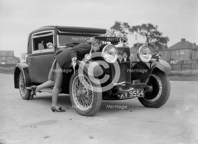 Kitty Brunell looking under the bonnet of a Talbot 14/45 sportsman's coupe, c1928. Artist: Bill Brunell.
