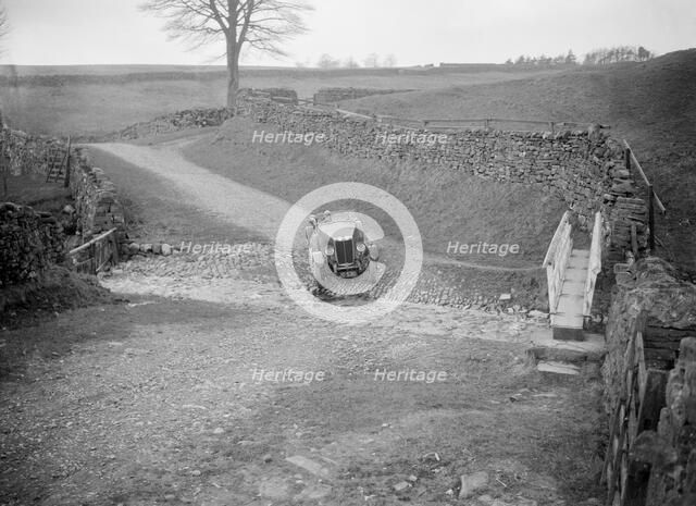 Kitty Brunell road testing a MG 18/80, Tan Hill, Yorkshire, April 1931. Artist: Bill Brunell.