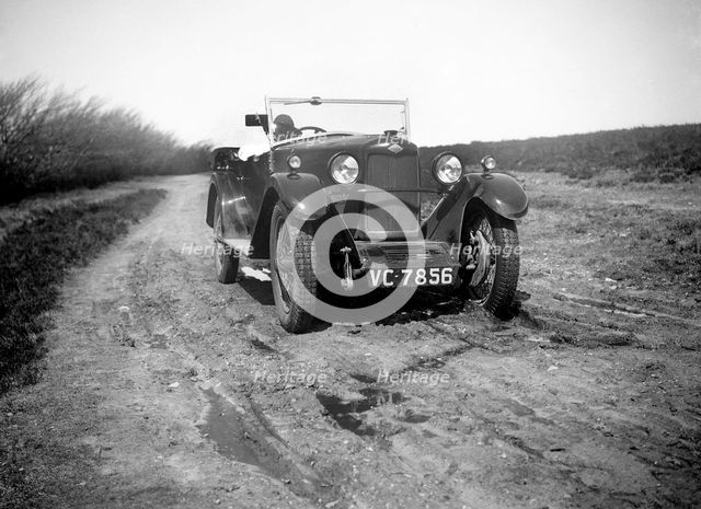 Kitty Brunell road testing a Riley 9 tourer, c1930.  Artist: Bill Brunell.