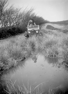 Kitty Brunell road testing a Riley 9 WD tourer, c1930. Artist: Bill Brunell