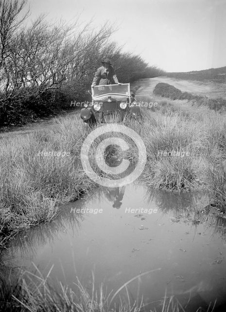 Kitty Brunell road testing a Riley 9 WD tourer, c1930. Artist: Bill Brunell.