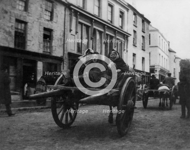 Killarney - 3 Irish women going to a funeral in a horse-drawn cart, (1899?). Creator: Frances Benjamin Johnston.