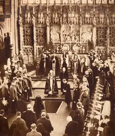 King Edward VIII sprinkles earth on his father's coffin, 1936