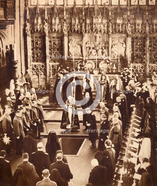 King Edward VIII sprinkles earth on his father's coffin, 1936.  Artist: Unknown.