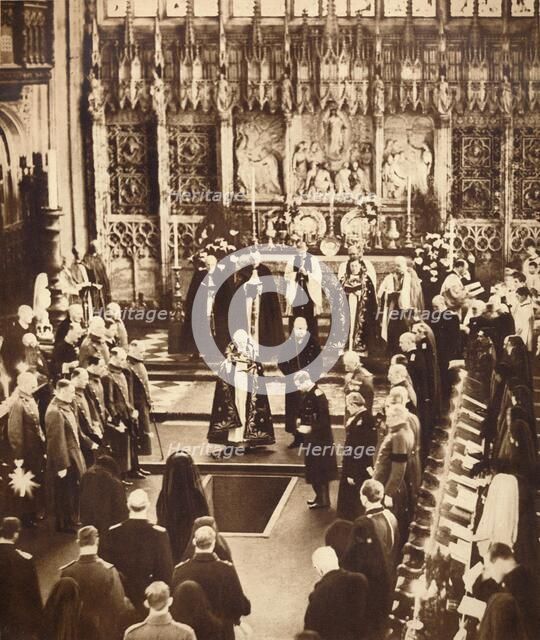 King Edward VIII sprinkles earth on his father's coffin, 1936.  Artist: Unknown.