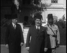King Faud I Accompanied by One Male Civilian and One Male Soldier Walking Down Steps, 1924. Creator: British Pathe Ltd