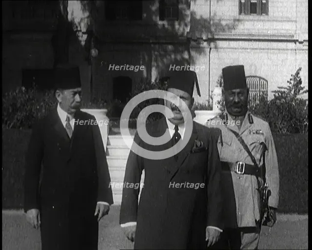 King Faud I Accompanied by One Male Civilian and One Male Soldier Walking Down Steps, 1924. Creator: British Pathe Ltd.