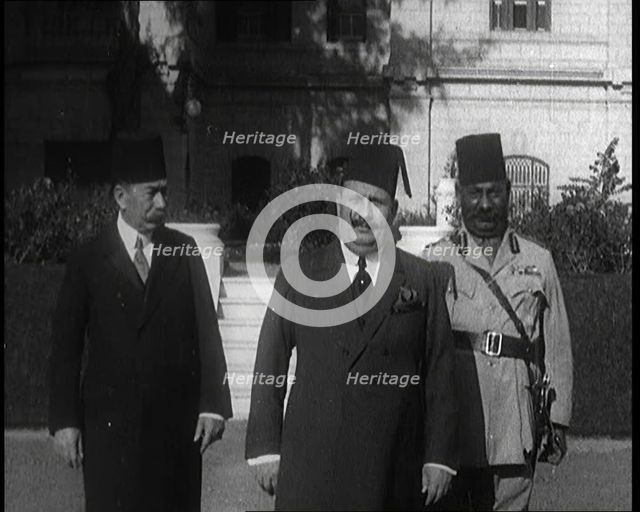 King Faud I Accompanied by One Male Civilian and One Male Soldier Walking Down Steps, 1924. Creator: British Pathe Ltd.